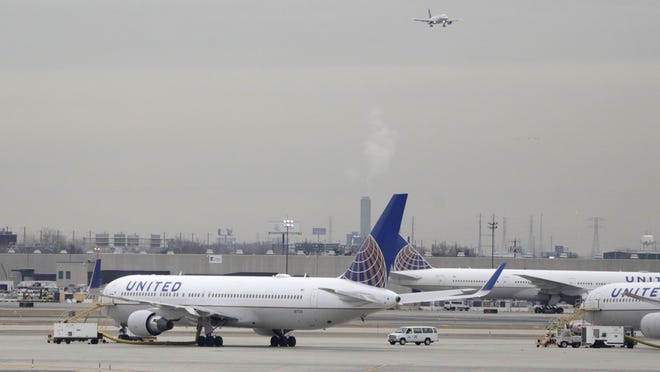 United Airlines jets are seen as a plane approaches Newark Liberty International Airport, in Newark, N.J., in this file photo. Federal authorities on March 11, 2019, say a United Airlines flight declared an emergency when an engine shut down as the plane descended into Houston.