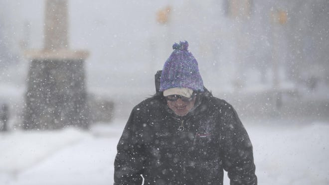 Francis Rotenberger, of Rapid City, S.D., walks home through Memorial Park in the snow in downtown Rapid City Wednesday, March 13, 2019. A window-rattling storm brought blizzards, floods and a tornado across more than 25 states Wednesday, stretching from the northern Rocky Mountains to Texas and beyond. (Ryan Hermens/Rapid City Journal via AP)