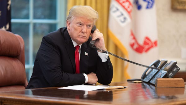 President Trump on the phone in the Oval Office.