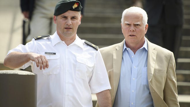 FILE - In this June 27, 2019, filke photo. Maj. Mathew Golsteyn, a former Army Special Forces soldier, leaves the Fort Bragg courtroom facility with his civilian lawyer, Phillip Stackhouse, right, after an arraignment hearing. President Donald Trump has pardoned a former U.S. Army commando set to stand trial next year in the killing of a suspected Afghan bomb-maker and for a former Army lieutenant who had been convicted of murder after he ordered his men to fire upon three Afghans, killing two, the White House announced late Friday. (Andrew Craft/The Fayetteville Observer via AP)