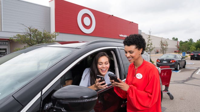 Target employee helping a customer in a car.