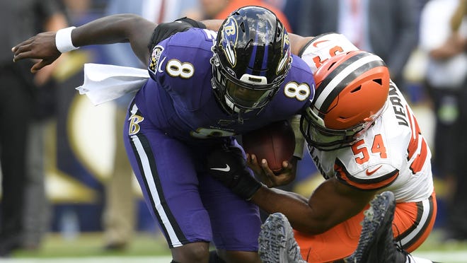 Browns defensive end Olivier Vernon sacks Baltimore Ravens quarterback Lamar Jackson during a game last season in Baltimore.