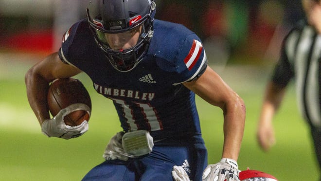 Wimberley senior Nathan Simpson, getting pulled down by a Fredericksburg defender, had 10 tackles and intercepted a pass in Friday's 21-20 victory.