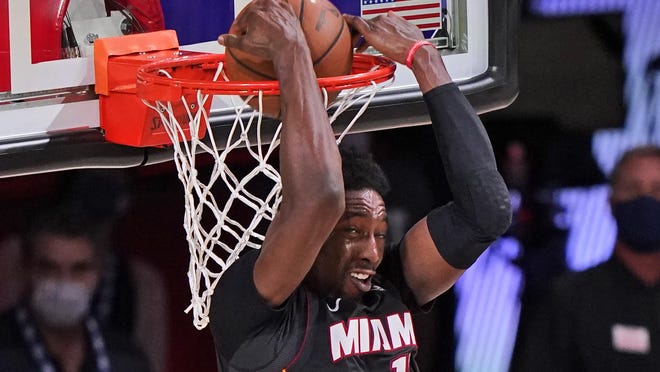 Miami Heat's Bam Adebayo (13) slams home a backward dunk Sunday in Lake Buena Vista, Fla.