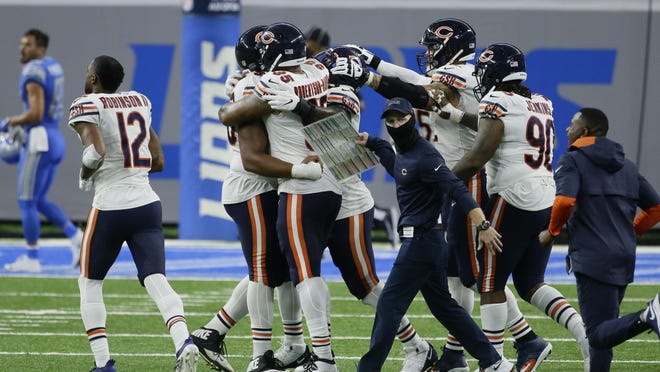Chicago Bears players celebrate after beating the Detroit Lions 27-23 after an NFL football game in Detroit, Sunday, Sept. 13, 2020.