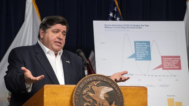 In this April 23, file photo, Gov. J.B. Pritzker speaks at the Thompson Center in Chicago. Pritzker said Wednesday, the focus during the coronavirus pandemic should be on protecting communities and not whether families should decide if sons and daughters strap on football helmets or start spiking volleyballs.