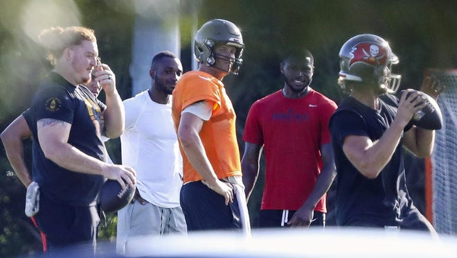 Tampa Bay Buccaneers center Ryan Jensen, far left, along with safety Mike Edwards, second from left, quarterback Tom Brady, center in orange, cornerback Jamel Dean, second from right, and quarterback Blaine Gabbert are seen during a private workout Tuesday, June 23, 2020 at Berkeley Preparatory School in Tampa.