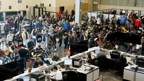 In this Jan. 2 file photo, people line up at a...