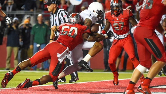 
Rutgers’ Quentin Gause attempts to stop Penn State’s Bill Belton in Piscataway, New Jersey.
