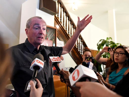 Governor Phil Murphy talks to reporters after attending