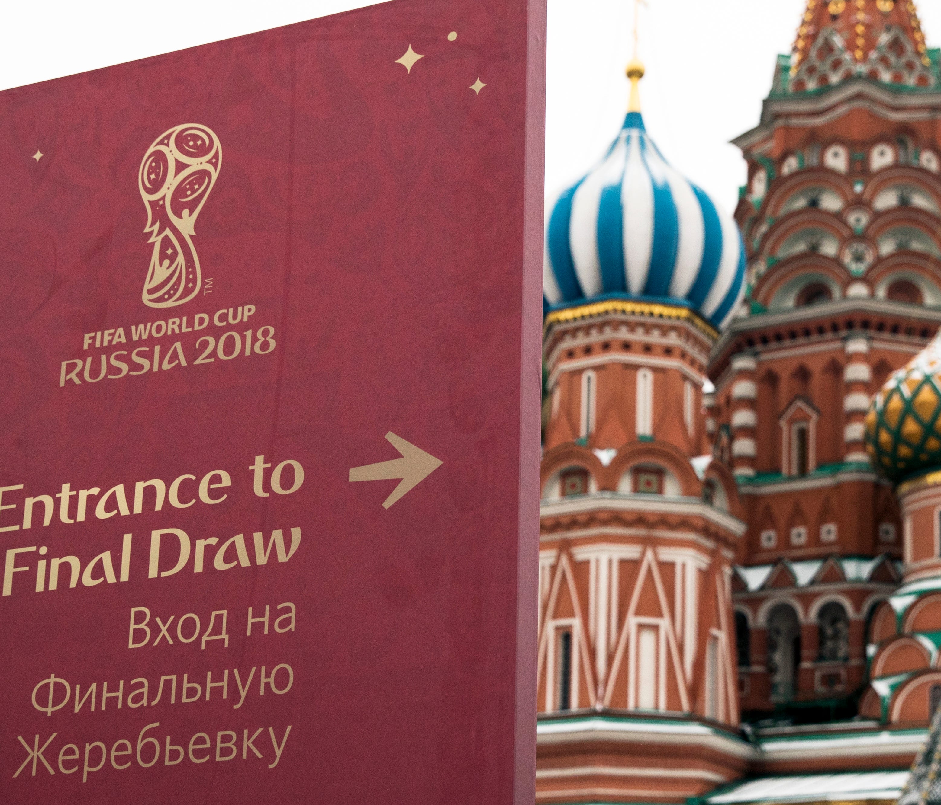 A signpost directing people to the entrance of the World Cup Final Draw is placed on the Red Square, with the St. Basil cathedral in the background, in Moscow, Russia, Thursday, Nov. 30, 2017. The Final Draw for the 2018 Fifa World Cup in Russia will
