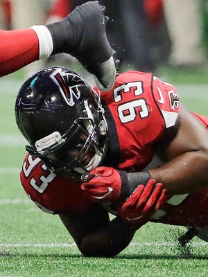 Arizona Cardinals running back James Summers (45) is tripped up by Atlanta Falcons defensive end Chris Odom (93) during the second half Saturday, Aug. 26, 2017, in Atlanta.