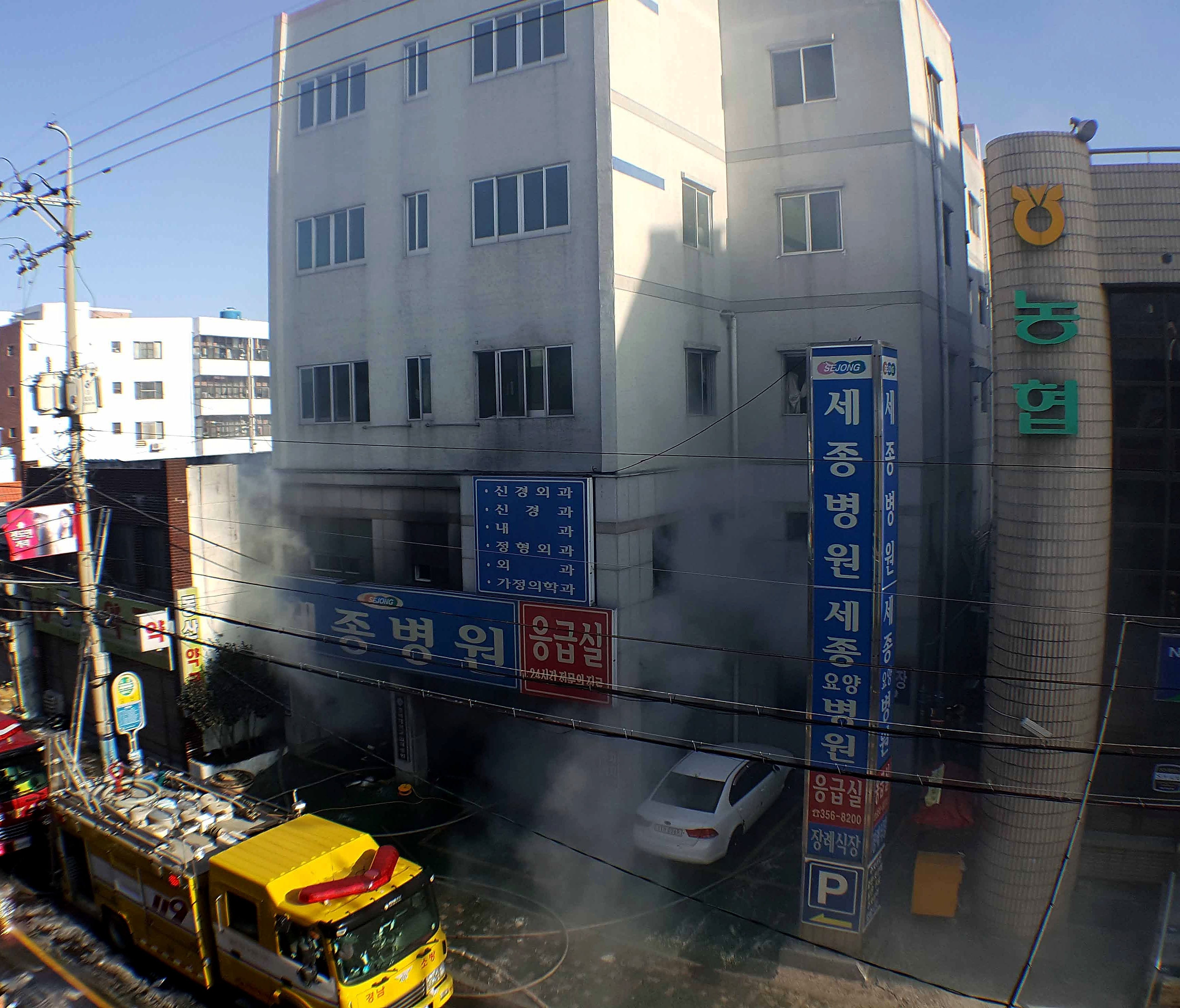 Rescue workers are pictured searching through a scorched, smoke-filled hospital in Miryang, South Korea.