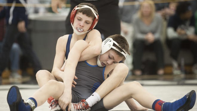 Washington Township's Tom Cole, back, controls Oakcrest's Frank Gabriel during the Region 8 Tournament last week. Cole placed fourth at 106 pounds and qualified for states.