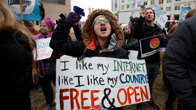 Lindsay Chestnut of Baltimore holds a sign that reads "I like My Internet Like I Like my Country Free & Open" as she protests near the Federal Communications Commission in Washington, D.C., in December.