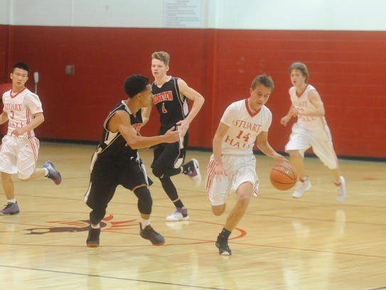 Stuart Hall's Cole Whitmore (14) takes the ball across