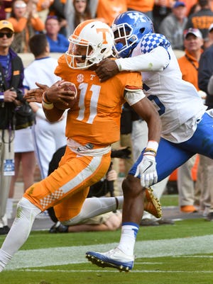 Tennessee quarterback Joshua Dobbs  shakes a Kentucky player to score a touchdown during the Vols' 49-36 victory Saturday at Neyland Stadium.