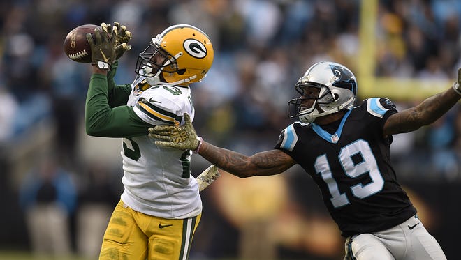 Green Bay Packers cornerback Damarious Randall (23) makes an interception in front of Carolina Panthers receiver Ted Ginn, Jr., (19) in the fourth quarter at Bank of America Stadium in Charlotte, N.C.