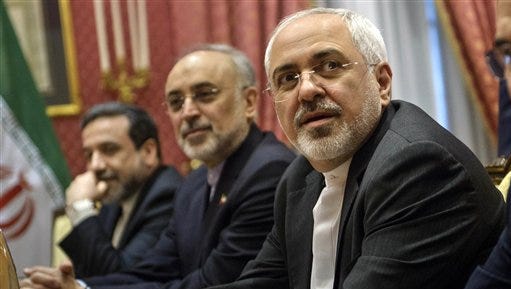 Iranian Foreign Mohammad Minister Javad Zarif , right, waits for the start of a meeting with a US delegation at a hotel in Lausanne Switzerland  on Thursday March 26, 2015 during negotiations on the Iranian nuclear programme. (AP Photo/Brendan Smialowski)