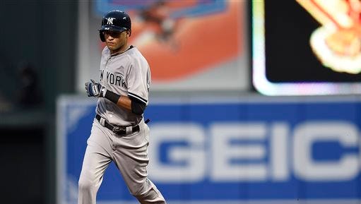 New York Yankees' Mason Williams rounds second base after hitting his first major league hit, a two-run home run, against the Baltimore Orioles in the fourth inning of a baseball game Friday, June 12, 2015, in Baltimore.