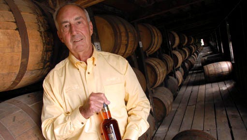 FILE - In this Sept. 20, 2006, file photo, Heaven Hill's master distiller Parker Beam holds a bottle of Rittenhouse Rye Whisky made at the Bardstown, Ky. distillery. Beam, who carried on his family's historic bourbon-making tradition, died Monday, Jan. 9, 2017, after battling amyotrophic lateral sclerosis, better known as Lou Gehrig's disease. He was 75. (AP Photo/Patti Longmire, File)