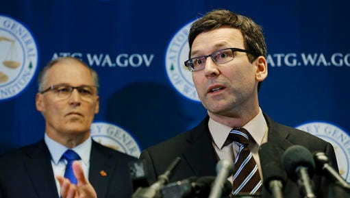 Washington Attorney General Bob Ferguson, right, talks to reporters as Gov. Jay Inslee, left, looks on, Monday, Jan. 30, 2017, in Seattle. Ferguson announced that he is suing President Donald Trump over an executive order that suspended immigration from seven countries with majority-Muslim populations and sparked nationwide protests.
