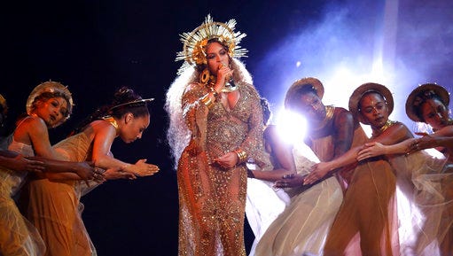 FILE - In this Feb. 12, 2017 file photo, Beyonce performs at the 59th annual Grammy Awards in Los Angeles. Lady Gaga will make history when she performs at the Coachella Valley Music and Arts festival this weekend, marking a decade since a solo woman has been billed as a headliner on the prestigious musical stage. Beyonce was originally slated to lead the history-making moment, but backed out because she is pregnant with twins.