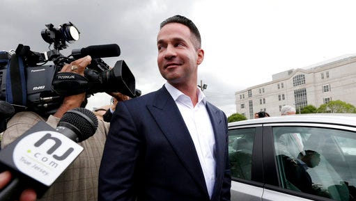 FILE - In this Sept. 24, 2014, file photo, reporters gather around Michael "The Situation" Sorrentino as he leaves the MLK Jr. Federal Courthouse in Newark, N.J., after a court appearance. Michael Sorrentino and his brother Marc Sorrentino are set to appear in court to face additional tax fraud charges are scheduled to be arraigned on Monday, April 17, 2017, in federal court in Newark. They previously pleaded not guilty to charges they filed bogus tax returns on nearly $9 million and claimed millions in personal expenses as business expenses.