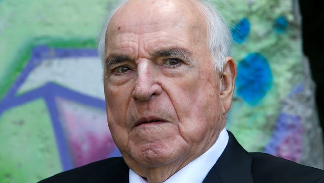 This May 16, 2014, photo shows former German Chancellor Helmut Kohl in front of a piece of the Berlin Wall in Kohl's garden in Oggersheim near Ludwigshafen, southwestern Germany.
