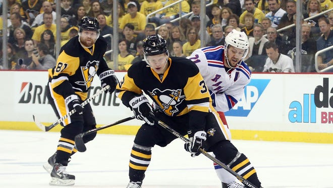 Pittsburgh Penguins defenseman Olli Maatta (3) handles the puck against New York Rangers center Derek Stepan (21) during the first period in game five of the first round of the 2016 Stanley Cup Playoffs at the CONSOL Energy Center.