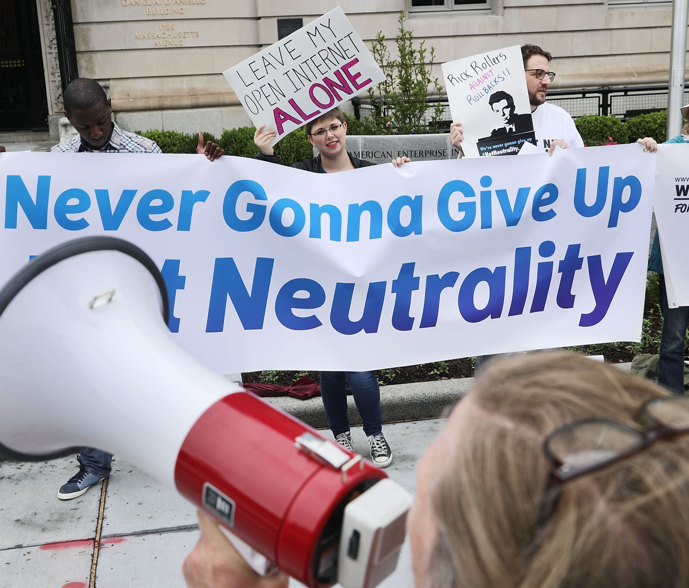 Proponents of net neutrality protest against Federal Communication Commission Chairman Ajit Pai outside the American Enterprise Institute before his arrival May 5, 2017 in Washington, DC. Pai, appointed to the FCC by President Obama in 2012, became c