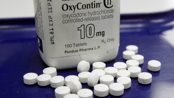 FILE - This Feb. 19, 2013, file photo, shows OxyContin pills arranged for a photo at a pharmacy in Montpelier, Vt. Two-thirds of the respondents in a Yahoo/Marist poll released Monday, April 17, 2017, said opioid drugs such as Vicodin or OxyContin are "riskier" to use than pot, even when the pain pills are prescribed by a doctor.