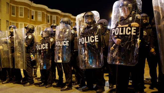 n this  2015 file photo, Baltimore police stand in formation as a curfew approaches in the ciity a day after unrest that occurred following the funeral of Freddie Gray', who died while in police custody.