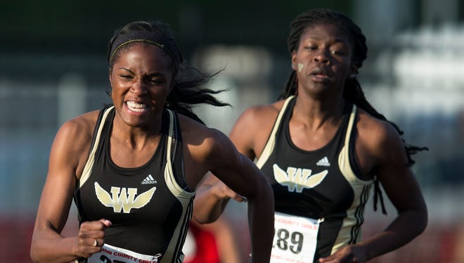 Breana Byrdsong (left), takes a handoff from Warren Central High School teammate Jasmyne Jordan in the 4 X 100 meter relay during the Marion County Girls Track, North Central High School,.