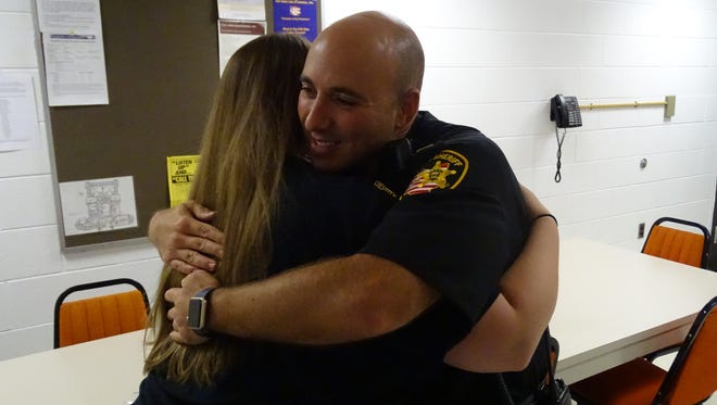 Overcome with joy, Sandusky County Sheriff Capt. Jamison Rose hugs Taylor Wamsley, of Fremont, who delivered sandwiches and fruit to the department as part of previous Law Enforcement Appreciation week.