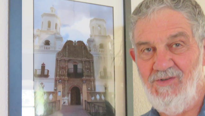 Photographer Tom Vaughan with his photo of San Javier del Bac, an old mission south of Tucson, Ariz.