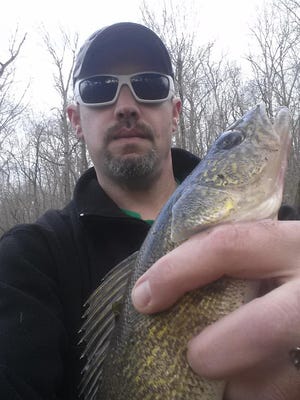 Brad Hailey, Walnut Grove, with a nice walleye he caught last weekend while fishing from the bank.