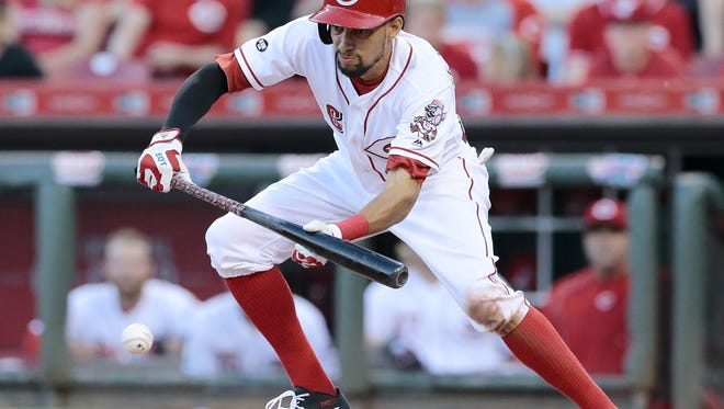 Cincinnati Reds center fielder Billy Hamilton (6) lays down a sacrifice bunt in the bottom of the fourth inning of the MLB National League game between the Cincinnati Reds and the St. Louis Cardinals at Great American Ball Park on Tuesday, June 7, 2016. After four innings, the Reds led 4-1.