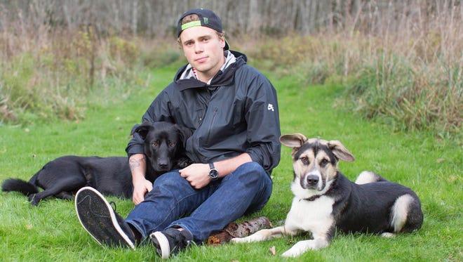 U.S. Olympic silver medalist Gus Kenworthy poses with dogs he rescued from Sochi in 2014.