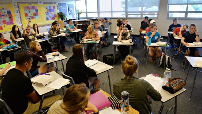 Students in Jen Musci's English class discuss Ernest Hemingway's short story "Hills Like White Elephants" at Poudre High School earlier this year.