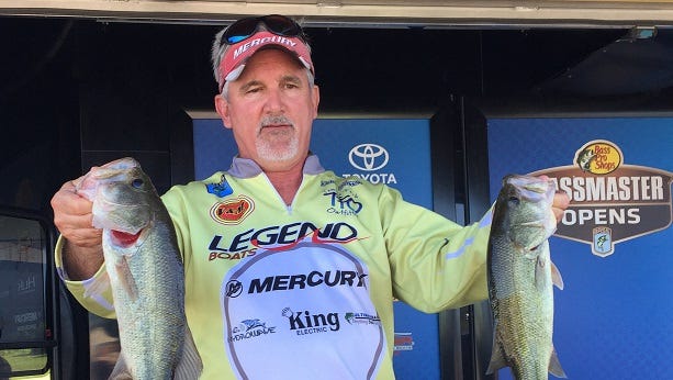 Elm Grove's David Sherrer holds up part of the stringer he weighed in Thursday during the Bass Pro Shops Bassmaster Central Open at the Red River South Marina.
