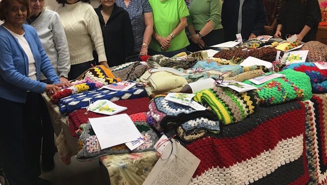 Members of the Knitting and Crocheting Club at 55 Kip Center in Rutherford prepare to send their homemade blankets to recovering veterans in North Carolina and Washington D.C. with the help of the Nassau County Firefighters, Operation Wounded Warrior.