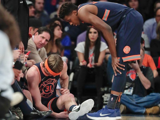 New York Knicks guard Ron Baker (31) sits on the sideline