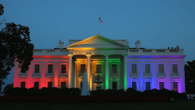 The white house illuminated by a rainbow of lights.
