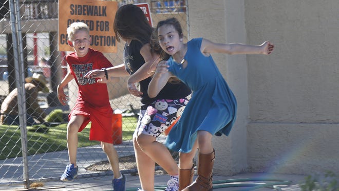 Hayden Rust, 10, chases down Kat Bernier (center) and Ana Riccobuono as the group plays at Desert Breeze Park in Chandler, on March 13, 2017. Phoenix reached 92 degrees, tying the heat record for March 13 that was set in 1972. Highs are expected to reach the mid-90s by the weekend.