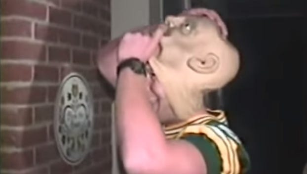 Green Bay Packers quarterback Brett Favre gleefully unmasks himself after going trick-or-treating at coach Mike Holmgren's house during the mid-1990s.