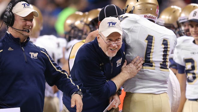 Tri-West High School head coach Chris Coll celebrates a touchdown with running back Wesley Cook in the second half of the game Tri-West defeated Andrean 49-27 in the IHSAA Class 3A State Football Finals at Lucas Oil Stadium on Saturday, Nov. 29, 2014.