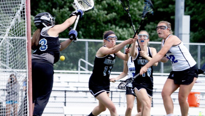 Bronxville's Hanna Bishop scores on Millbrook goalie Claire Martell during the Class D regional final lacrosse game at North Rockland High School June 3, 2017. Bronxville defeated Millbrook 15-4.
