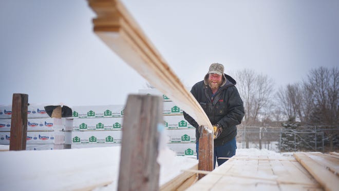 Yard technician Matt Schomaker prepares an order of lumber at Scott's Lumber & Supply Co. Tuesday, Feb. 6, in Sioux Falls. Schomaker receives orders from builders and then packages them for pick up. Lumber prices reached a record highs last week which affects pricing for homebuilders and homebuyers.