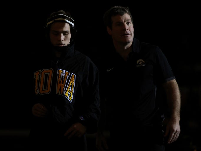 Iowa's Spencer Lee and head coach Tom Brands stand